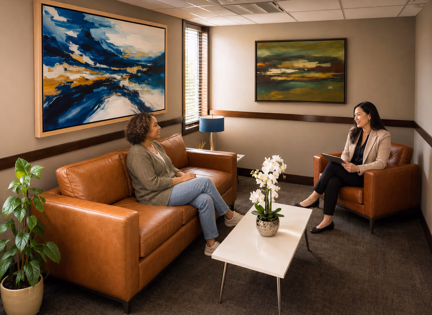 Two women sharing a conversation in a welcoming sitting room